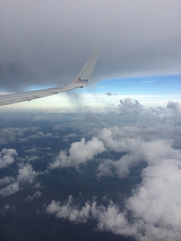 Airplane wing over clouds