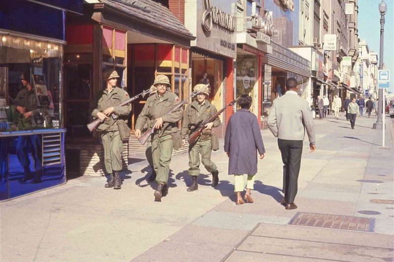 Troops walking a District sidewalk during the 1968 uprising